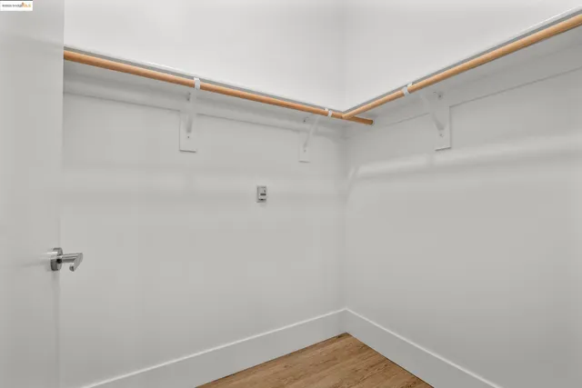 a bed room with a bed and a night stand