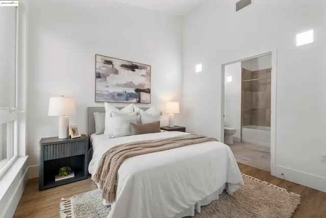 a bedroom with a bed and wooden floor