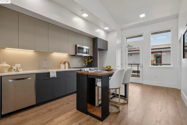 a kitchen with a sink cabinets and wooden floor