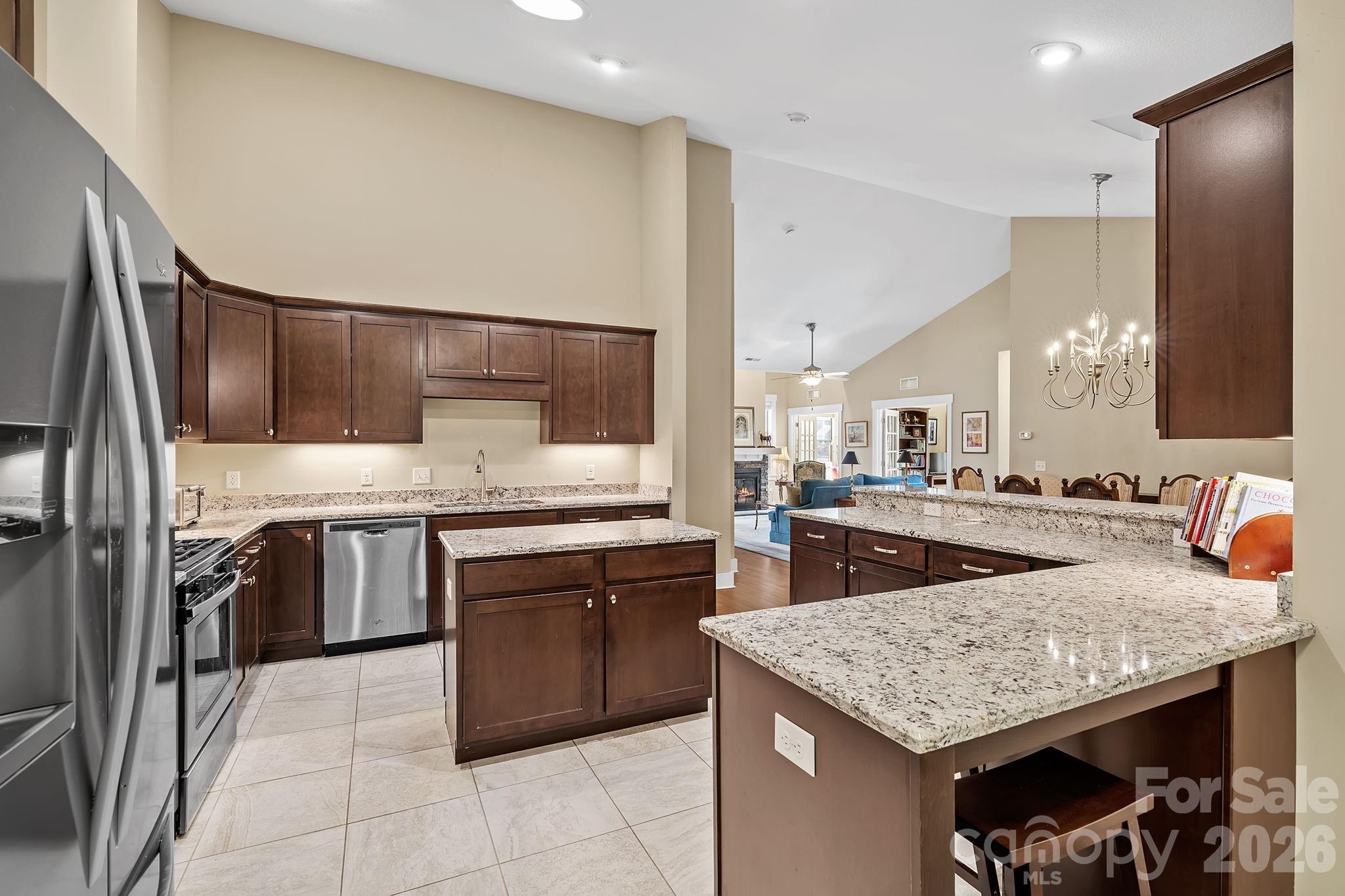 9 Brookstone Place Candler, NC 28715 - Photo 11 of 36 a kitchen with stainless steel appliances granite countertop a sink stove and refrigerator