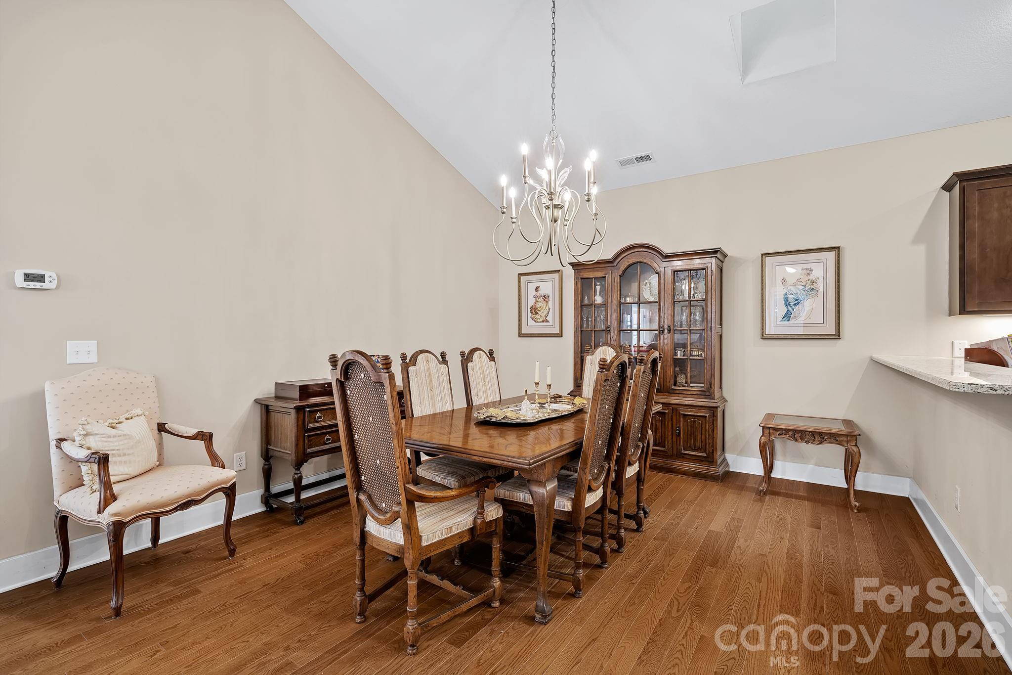 9 Brookstone Place Candler, NC 28715 - Photo 12 of 36 a view of a dining room with furniture wooden floor and chandelier