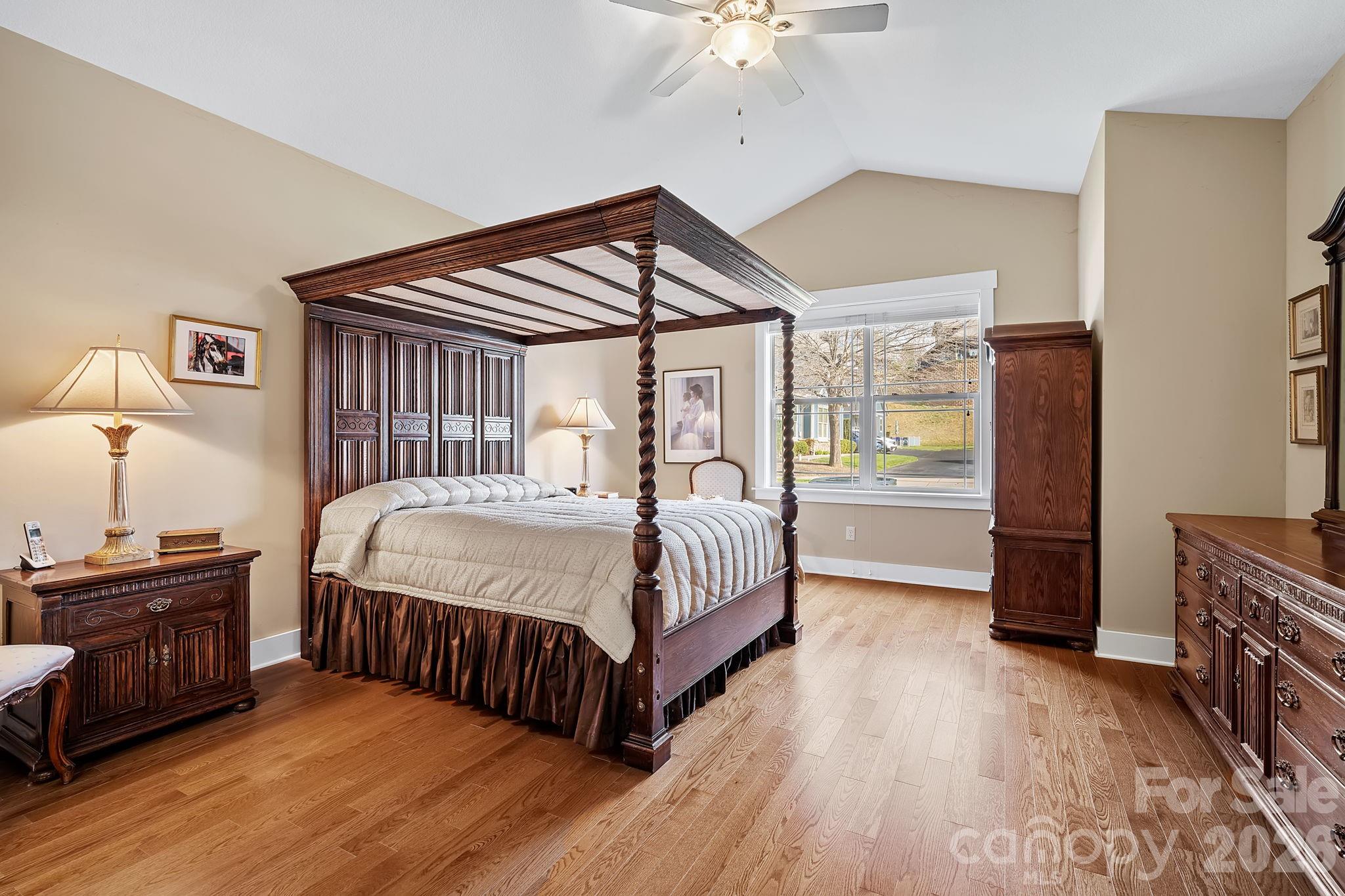 9 Brookstone Place Candler, NC 28715 - Photo 13 of 36 a bedroom with a bed and a chandelier