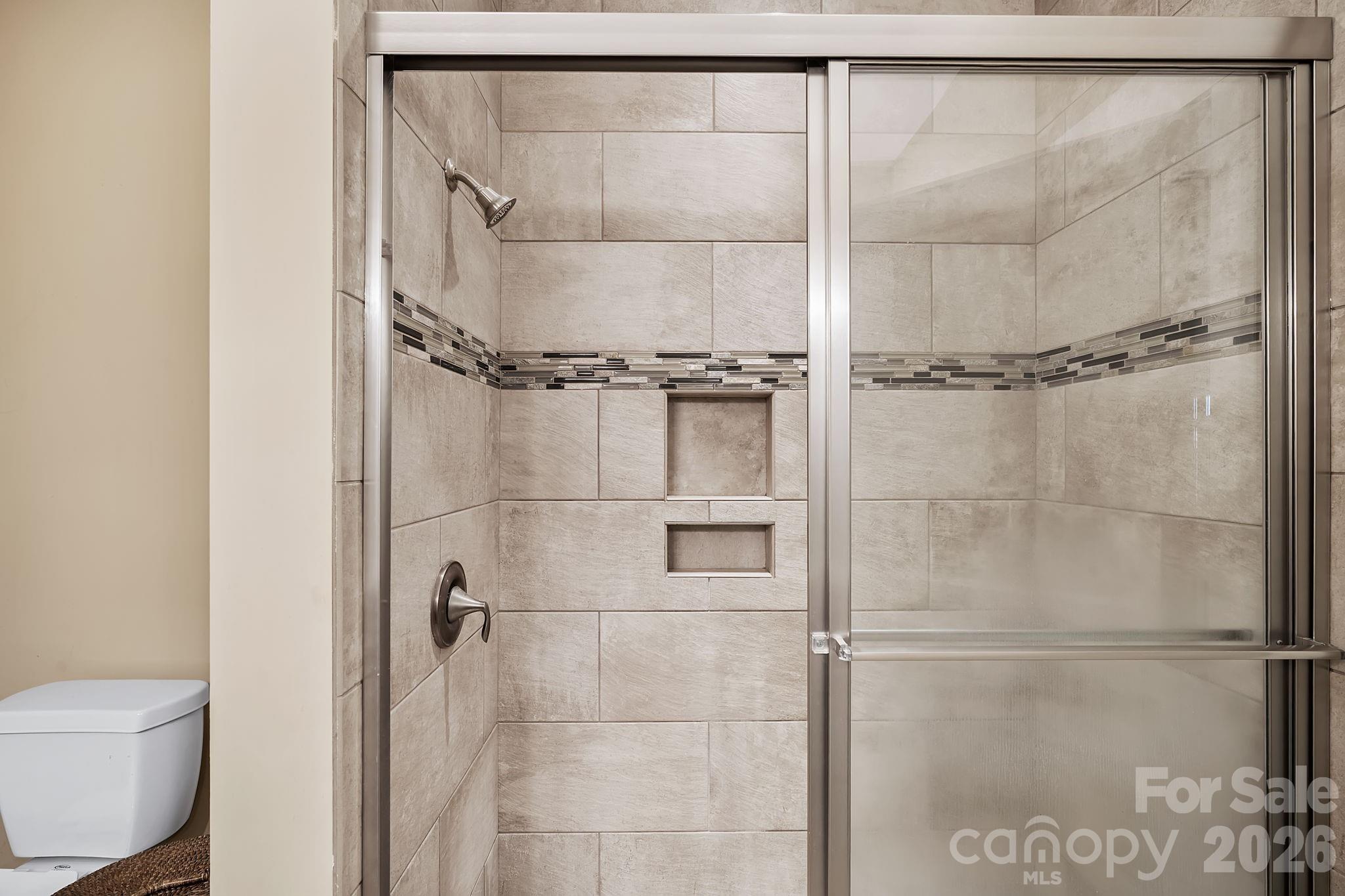 9 Brookstone Place Candler, NC 28715 - Photo 16 of 36 a bathroom with a shower and a toilet