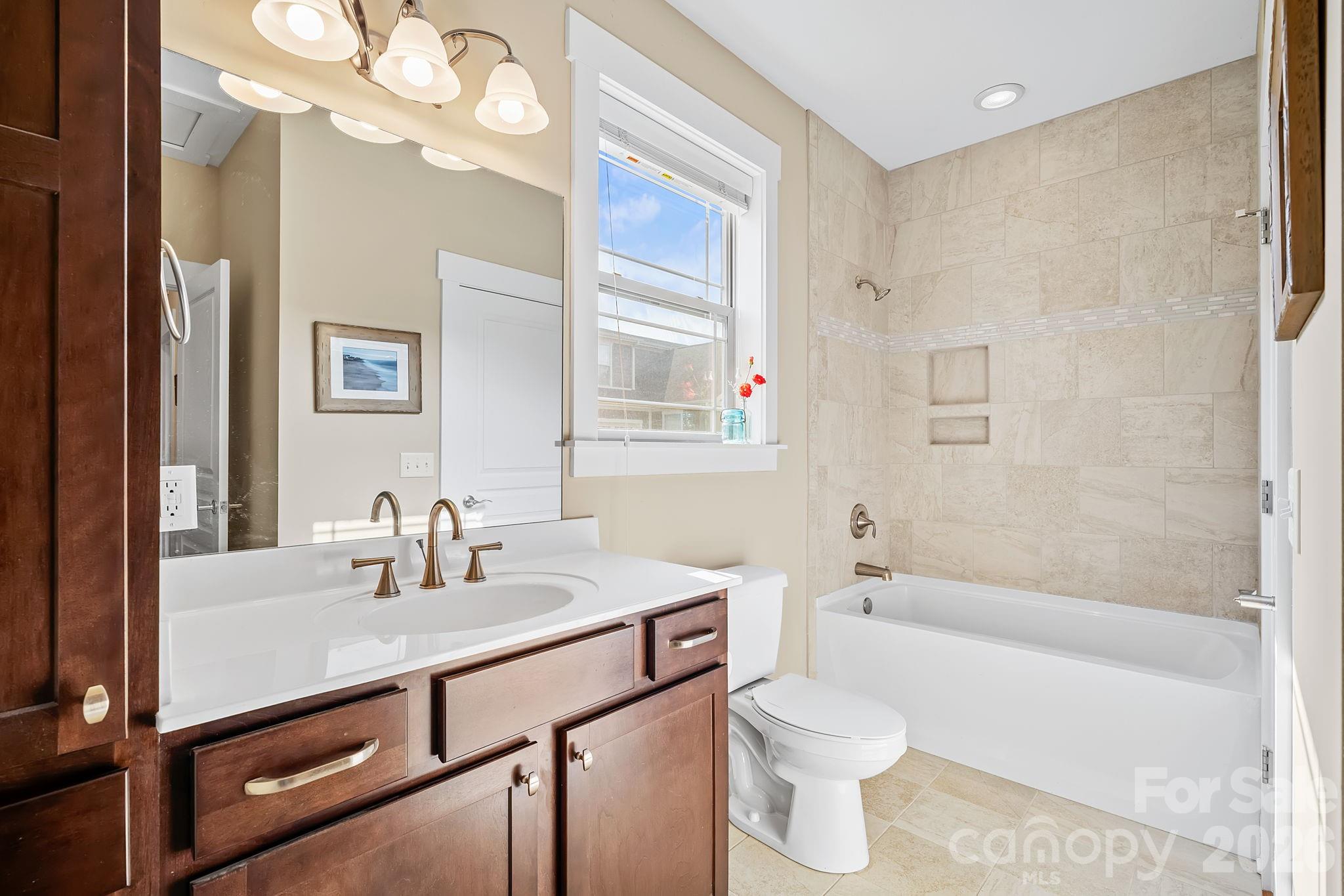 9 Brookstone Place Candler, NC 28715 - Photo 19 of 36 a bathroom with a sink a toilet and bathtub