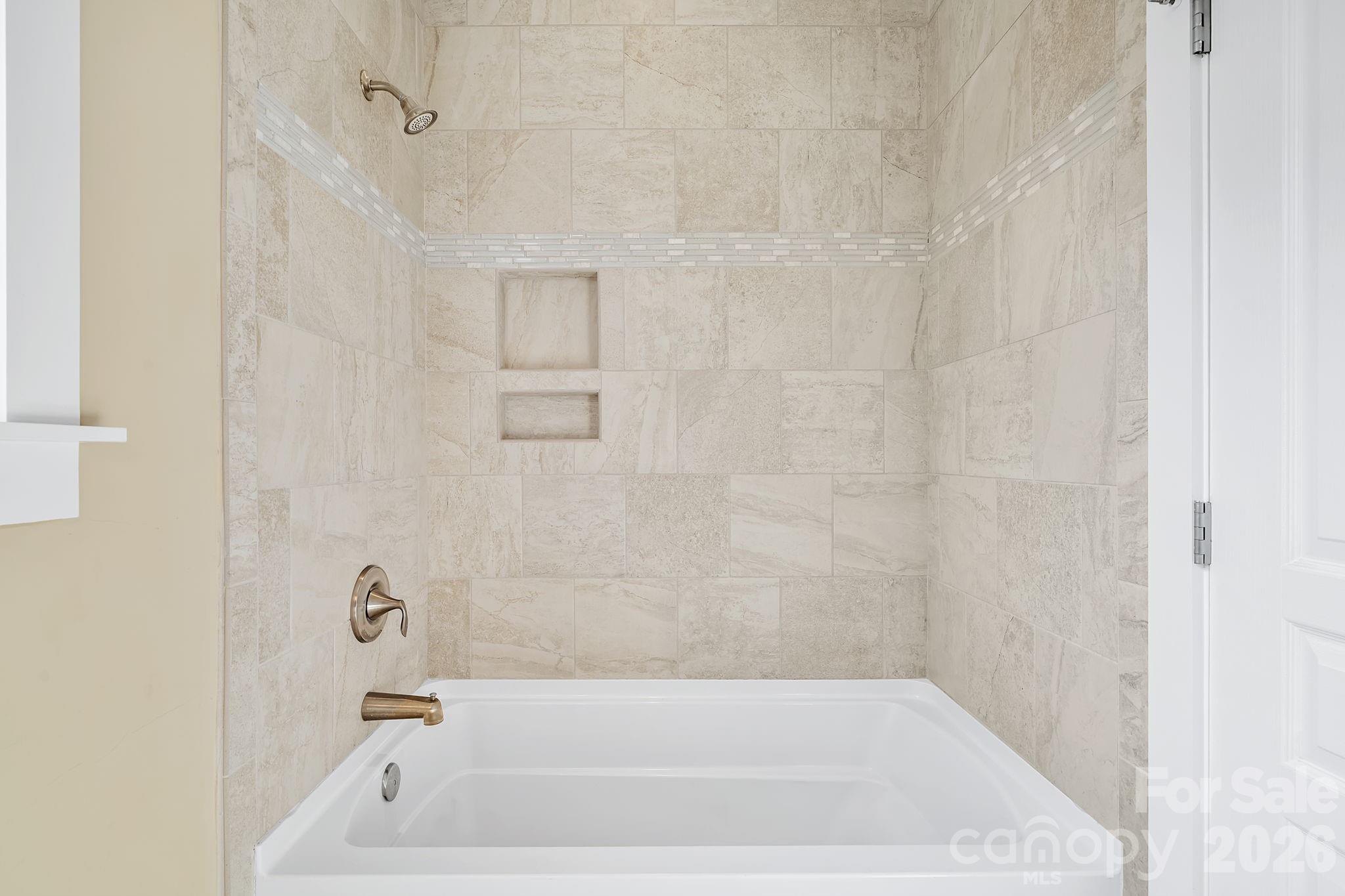 9 Brookstone Place Candler, NC 28715 - Photo 20 of 36 a bathroom with a bathtub