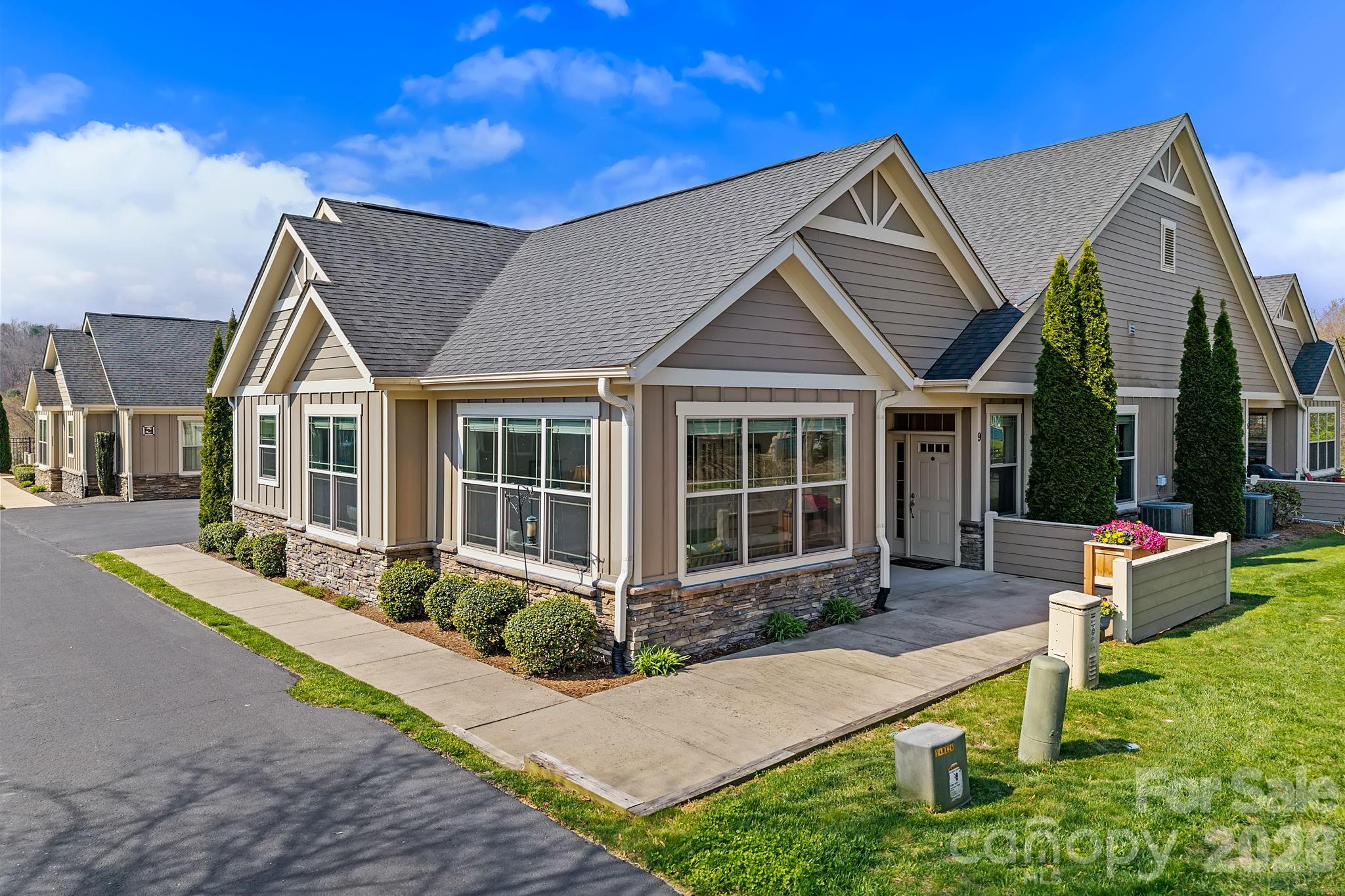 9 Brookstone Place Candler, NC 28715 - Photo 2 of 36 a front view of a house with garden
