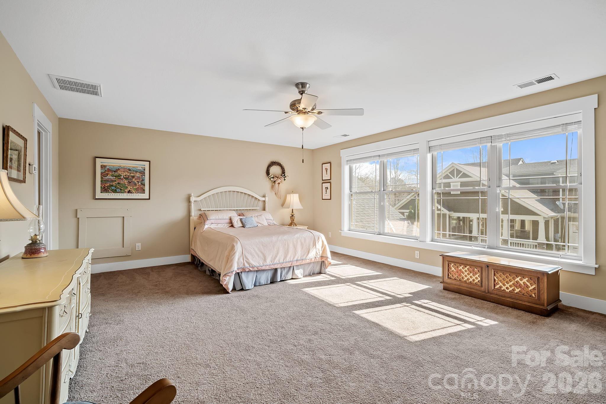 9 Brookstone Place Candler, NC 28715 - Photo 24 of 36 a spacious bedroom with a bed a couch and a window