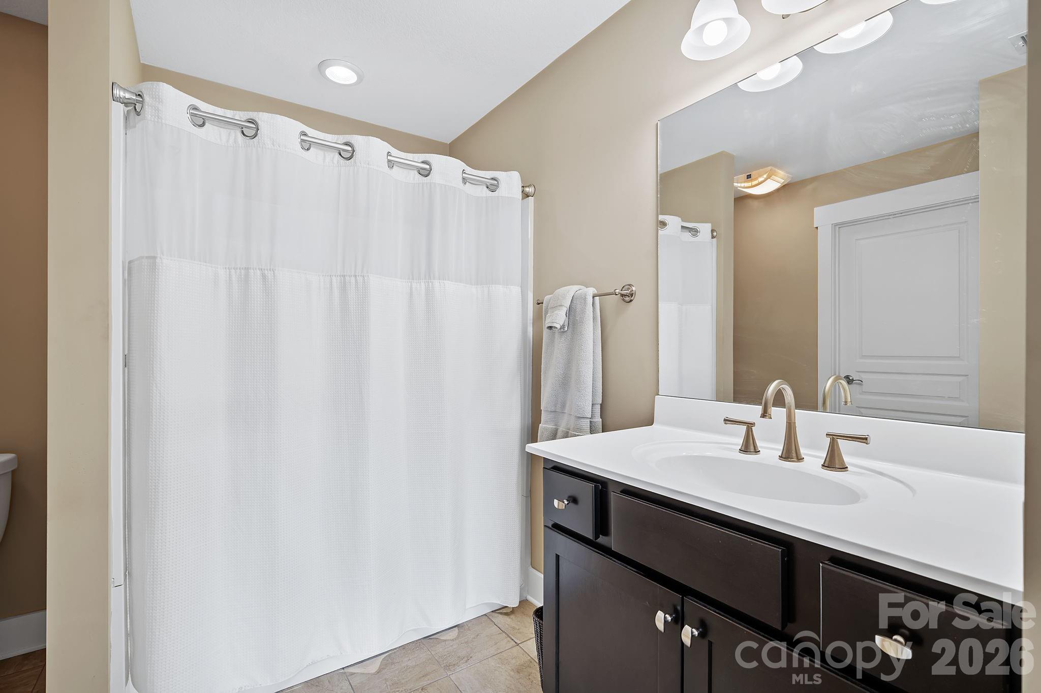 9 Brookstone Place Candler, NC 28715 - Photo 25 of 36 a bathroom with a sink vanity and a mirror
