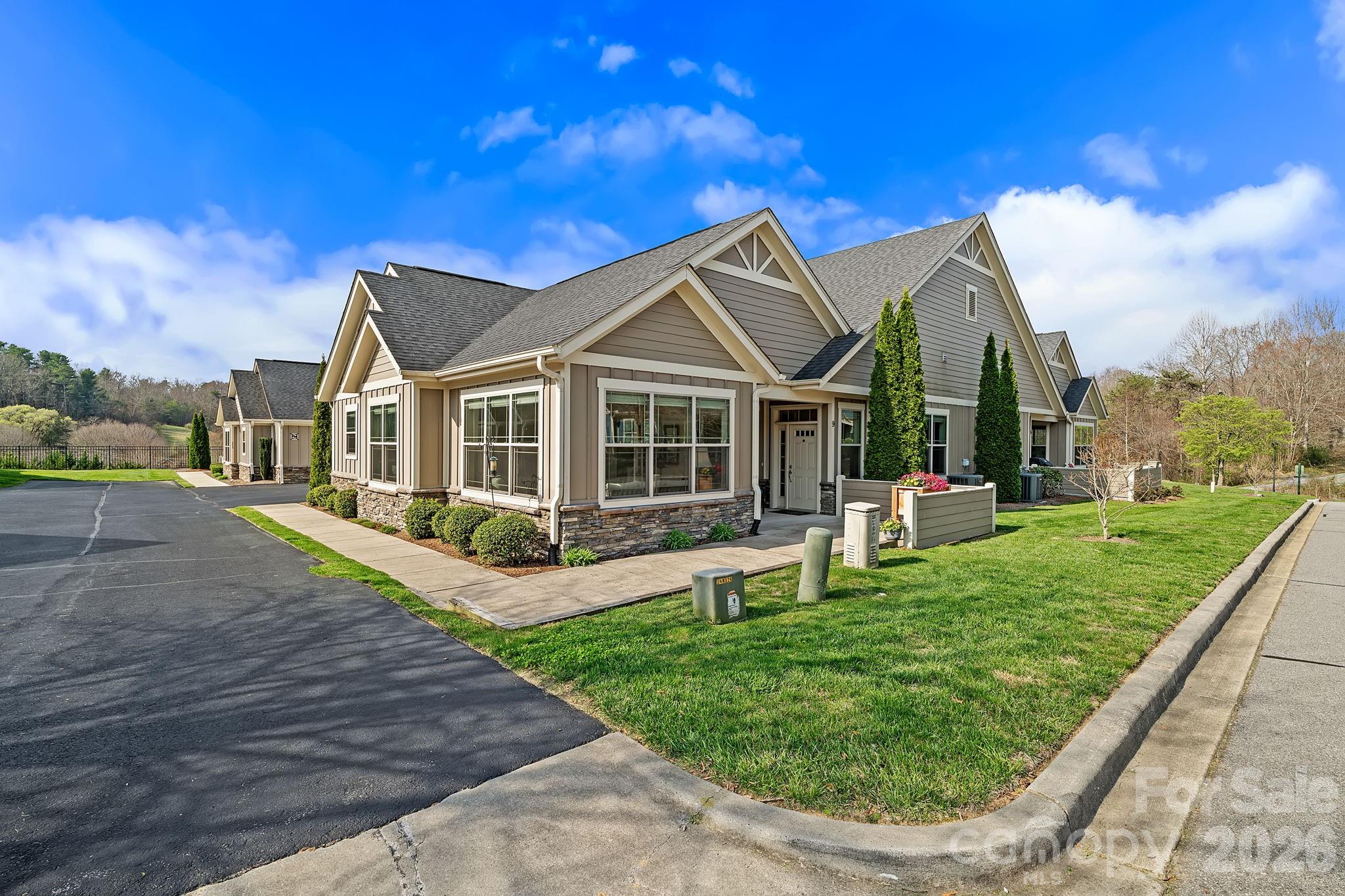 9 Brookstone Place Candler, NC 28715 - Photo 28 of 36 a view of a house with a big yard potted plants and large tree