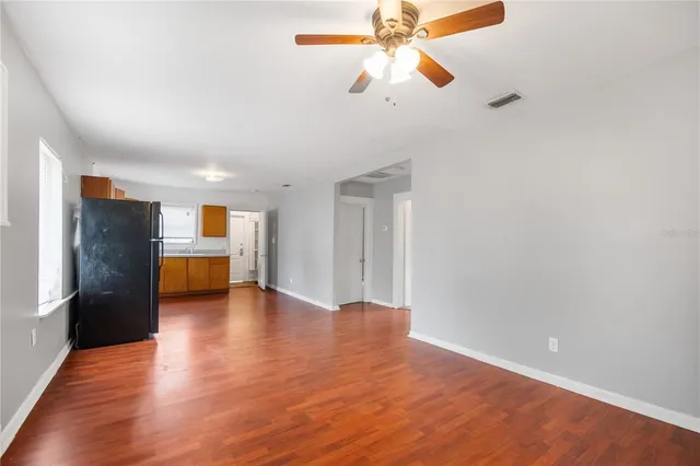a view of empty room with wooden floor
