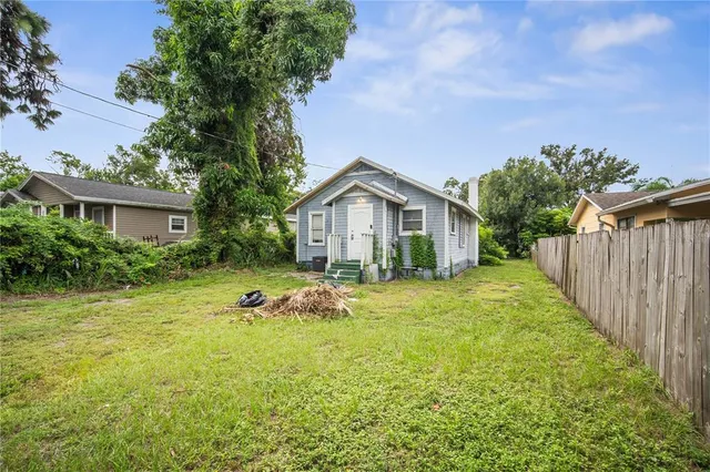 a backyard of a house with table and chairs