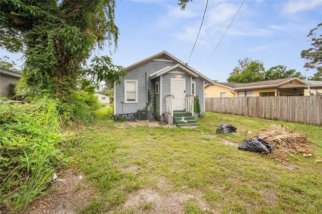 a backyard of a house with table and chairs