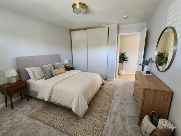 a bedroom with bed and a mirror