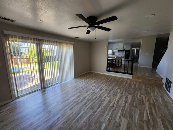 a view of wooden floor and a window in an empty room