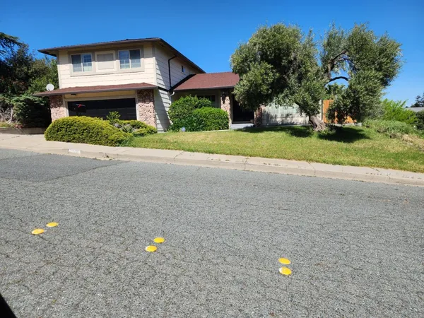 a front view of a house with a yard