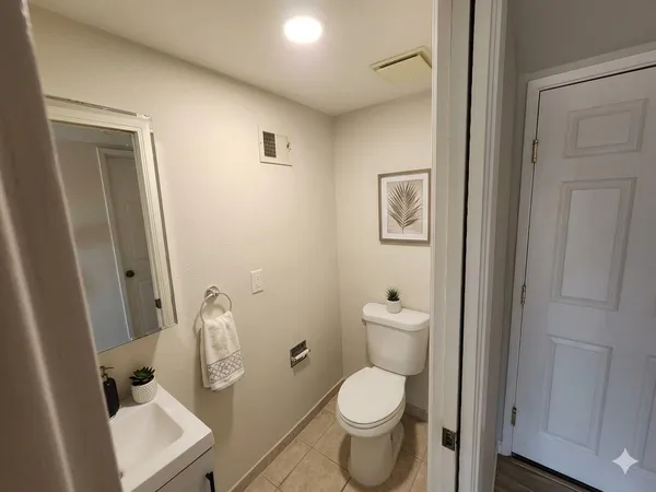 a white toilet sitting next to a bathroom sink