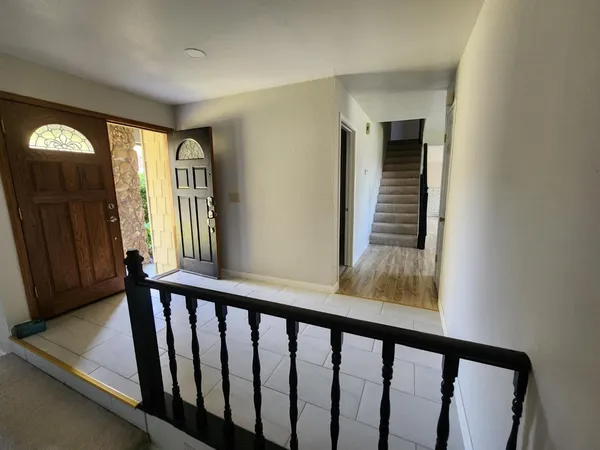 a view of a balcony with wooden floor and stairs