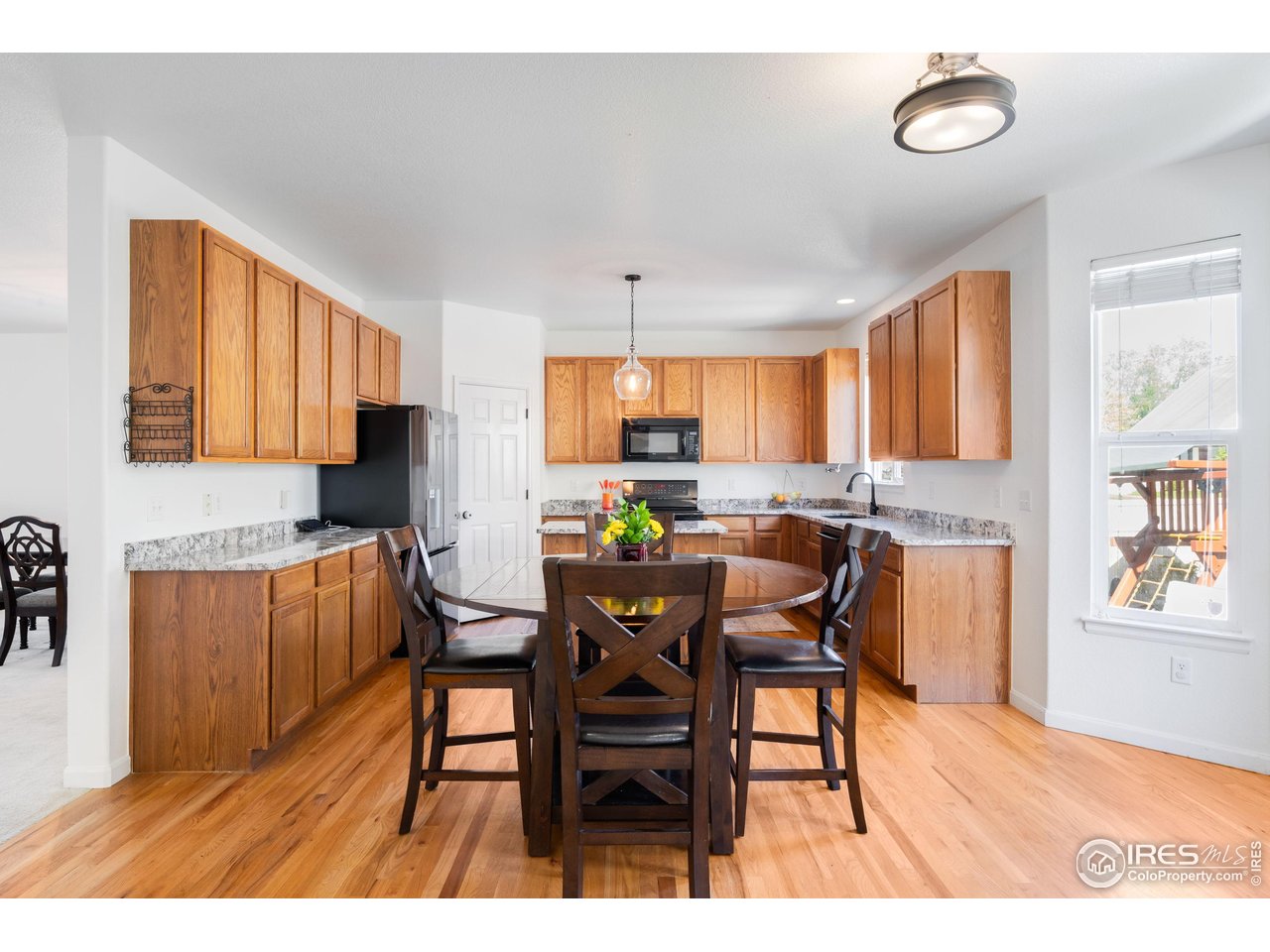 5861 Mountain Shadows Boulevard Firestone, CO 80504 - Photo 12 of 39 a view of a dining room with furniture and a window