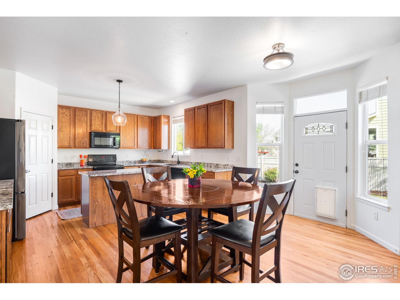 5861 Mountain Shadows Boulevard Firestone, CO 80504 - Photo 13 of 39 a view of a dining room with furniture and wooden floor