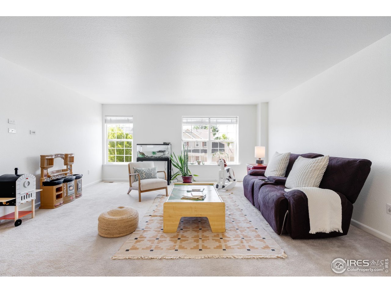 5861 Mountain Shadows Boulevard Firestone, CO 80504 - Photo 18 of 39 a living room with furniture and a flat screen tv