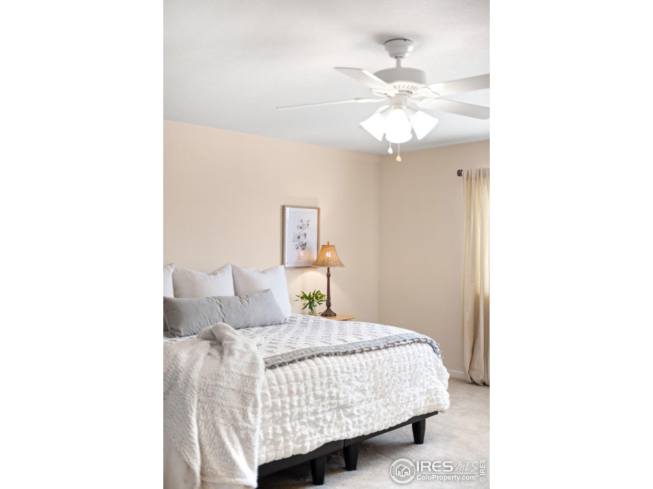 5861 Mountain Shadows Boulevard Firestone, CO 80504 - Photo 22 of 39 a bedroom with a bed and a chandelier