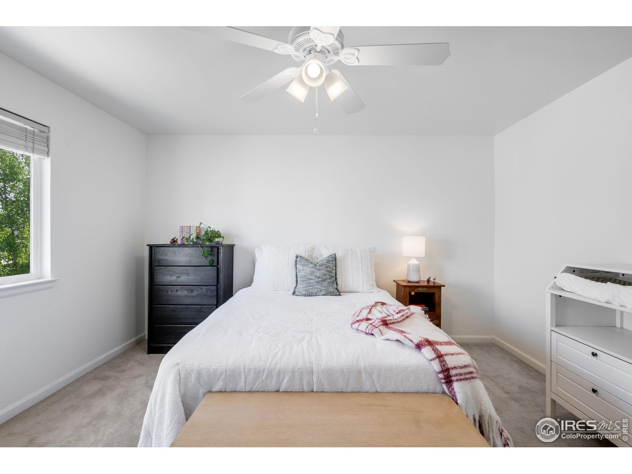 5861 Mountain Shadows Boulevard Firestone, CO 80504 - Photo 26 of 39 a bedroom with a bed and a dresser