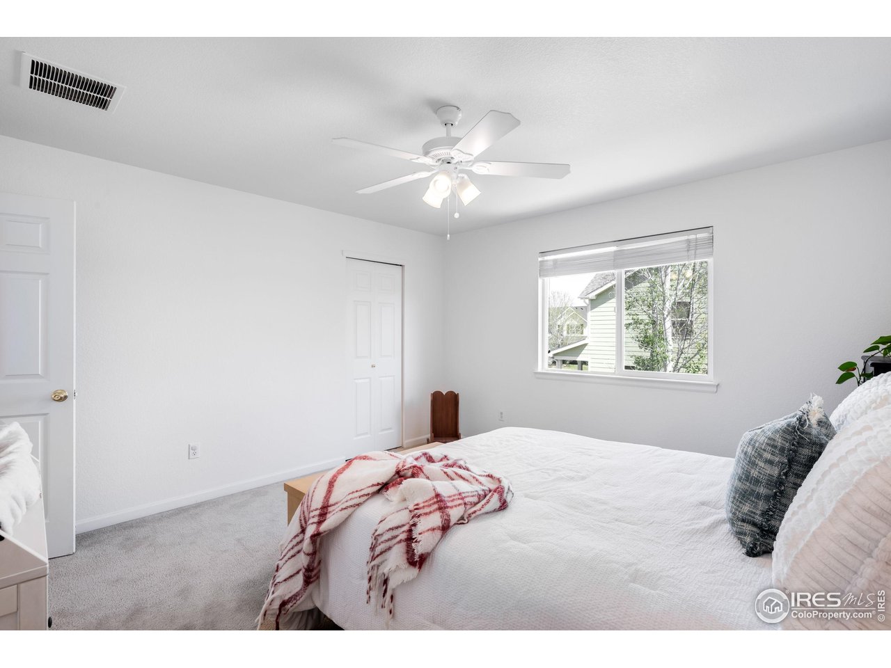 5861 Mountain Shadows Boulevard Firestone, CO 80504 - Photo 27 of 39 a bedroom with a large bed and a window