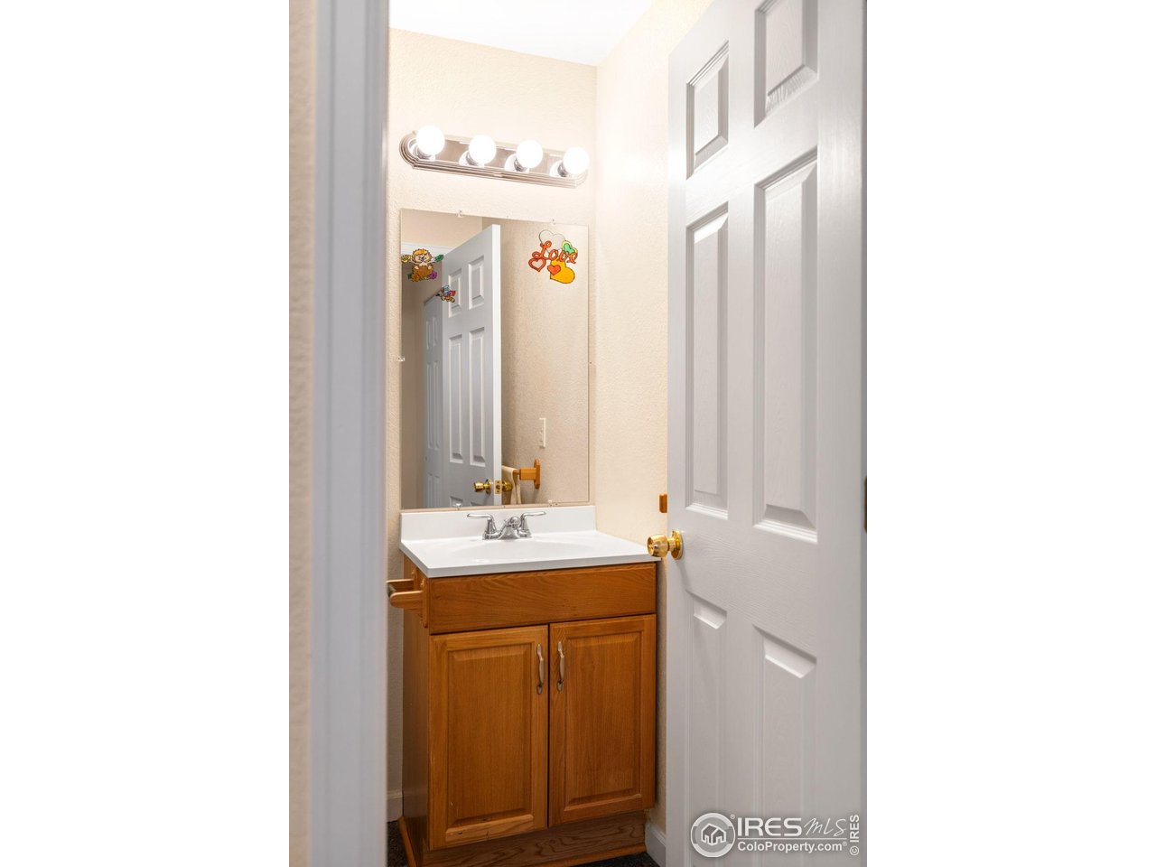 5861 Mountain Shadows Boulevard Firestone, CO 80504 - Photo 34 of 39 a bathroom with a sink and a mirror