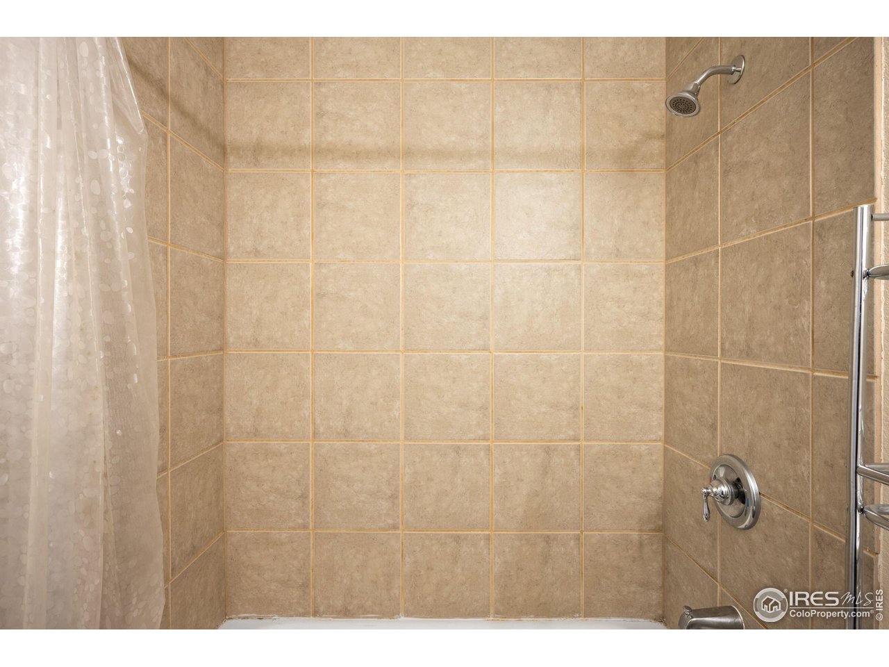 5861 Mountain Shadows Boulevard Firestone, CO 80504 - Photo 35 of 39 a bathroom with a shower curtain