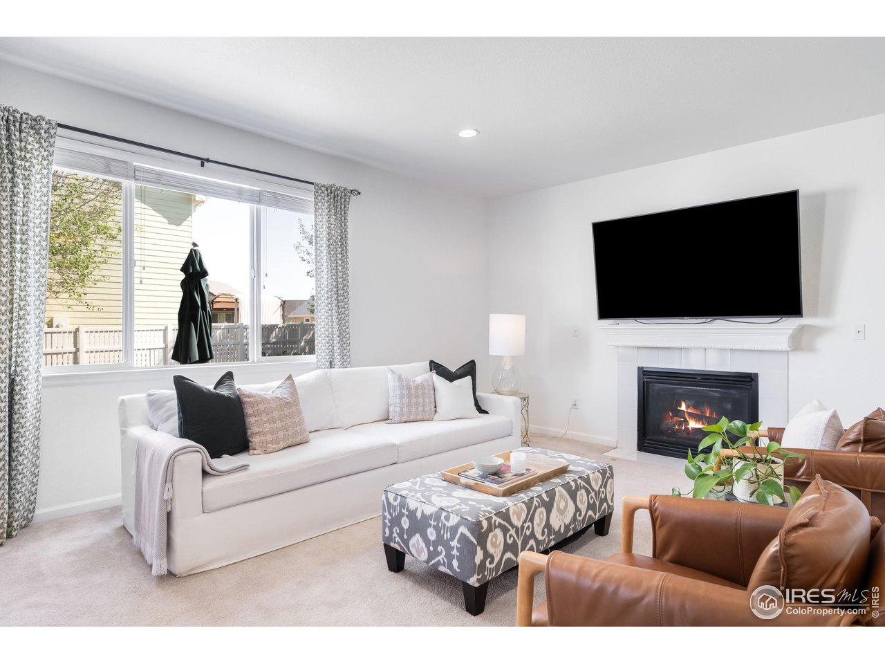 5861 Mountain Shadows Boulevard Firestone, CO 80504 - Photo 4 of 39 a living room with fireplace furniture and a flat screen tv