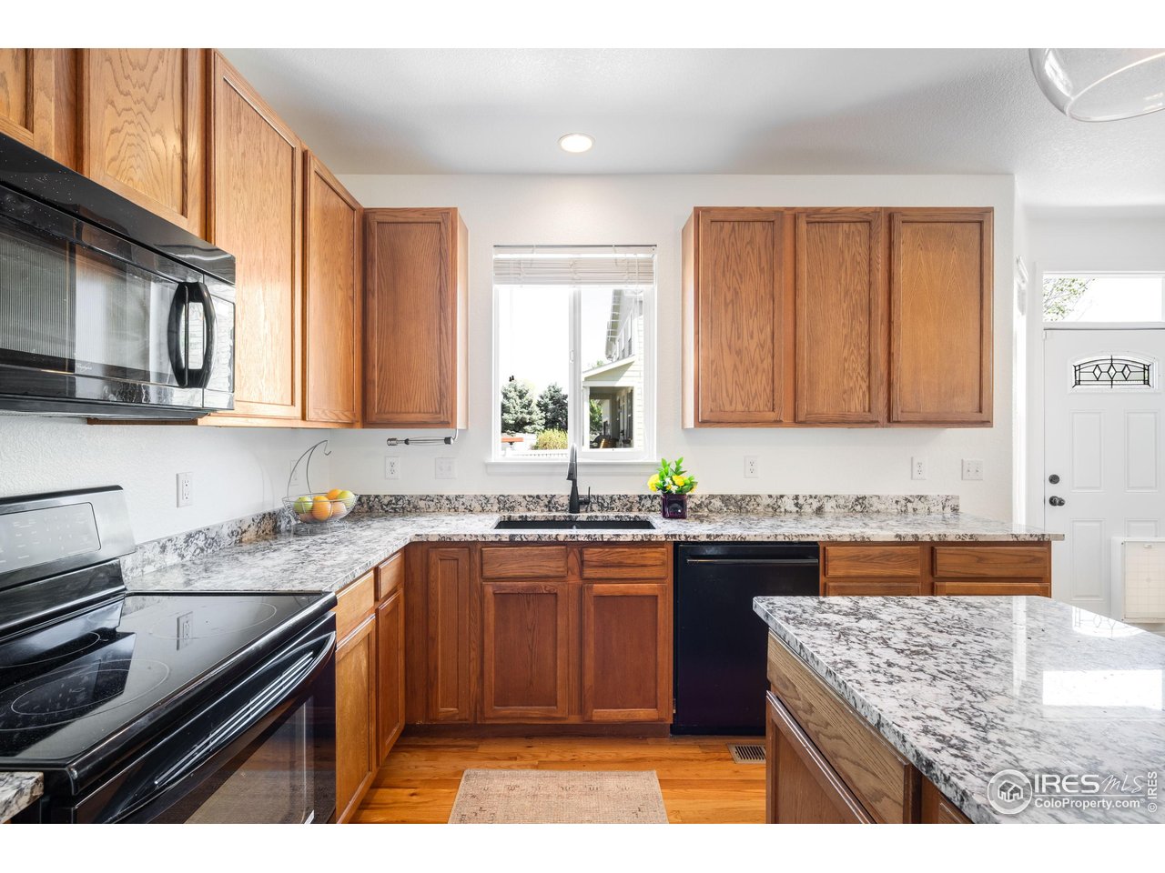 5861 Mountain Shadows Boulevard Firestone, CO 80504 - Photo 7 of 39 a kitchen with a sink a stove and cabinets