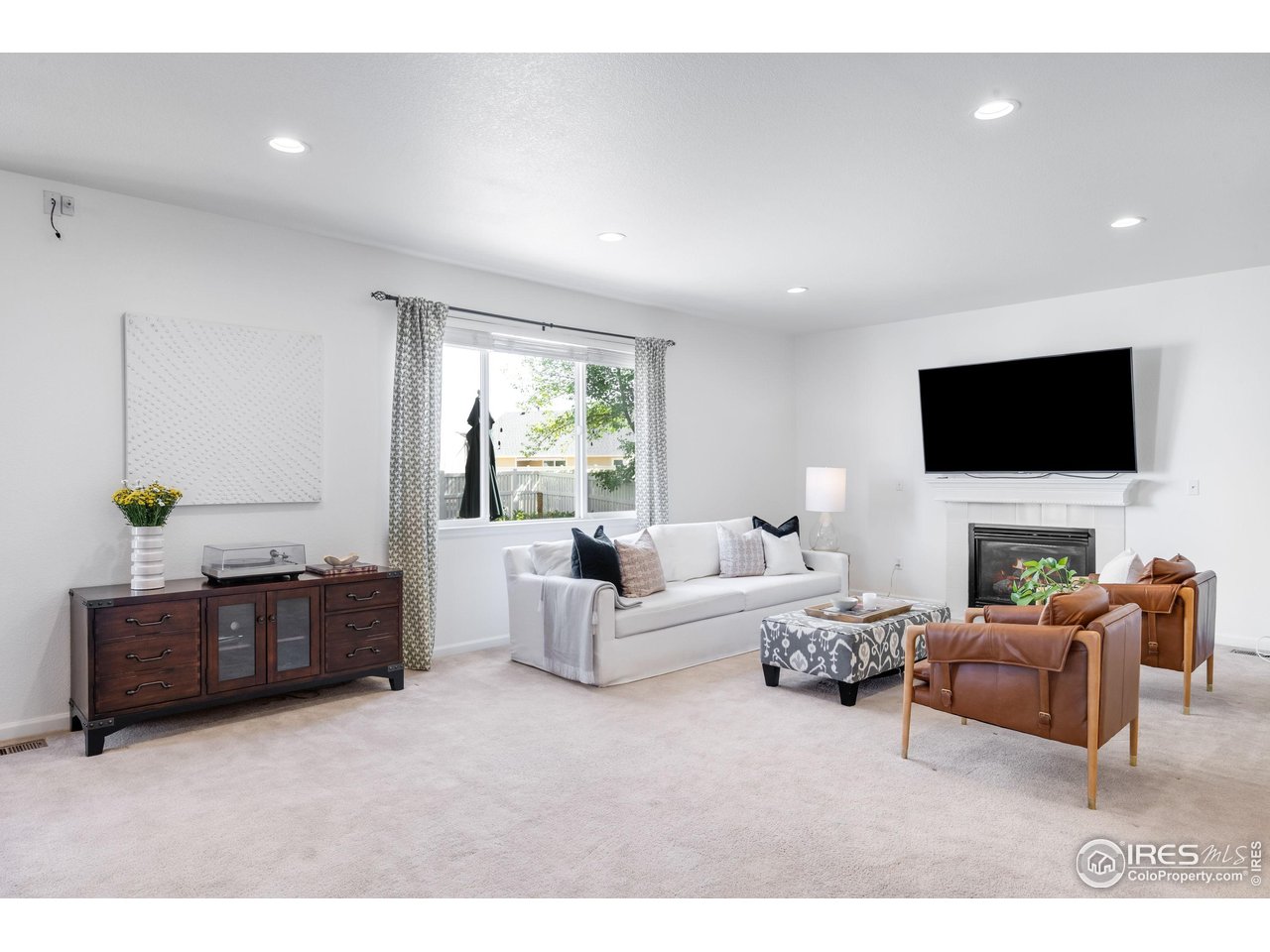 5861 Mountain Shadows Boulevard Firestone, CO 80504 - Photo 8 of 39 a living room with furniture and a flat screen tv