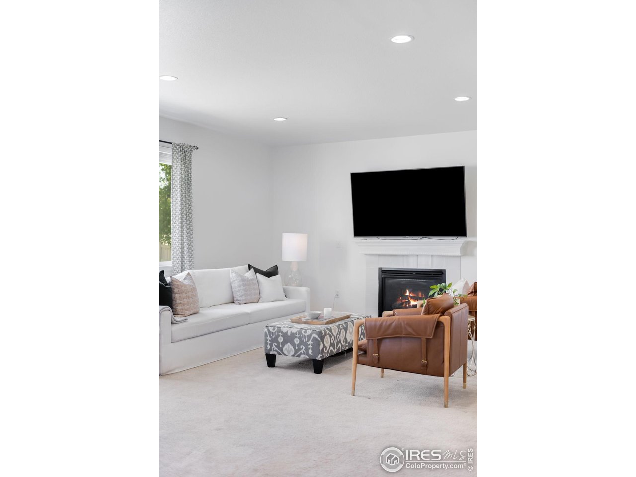 5861 Mountain Shadows Boulevard Firestone, CO 80504 - Photo 10 of 39 a living room with furniture and a flat screen tv
