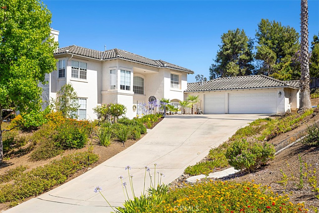 1957 Cresthaven Drive Vista, CA 92084 - Photo 1 of 47 a front view of a house with a garden