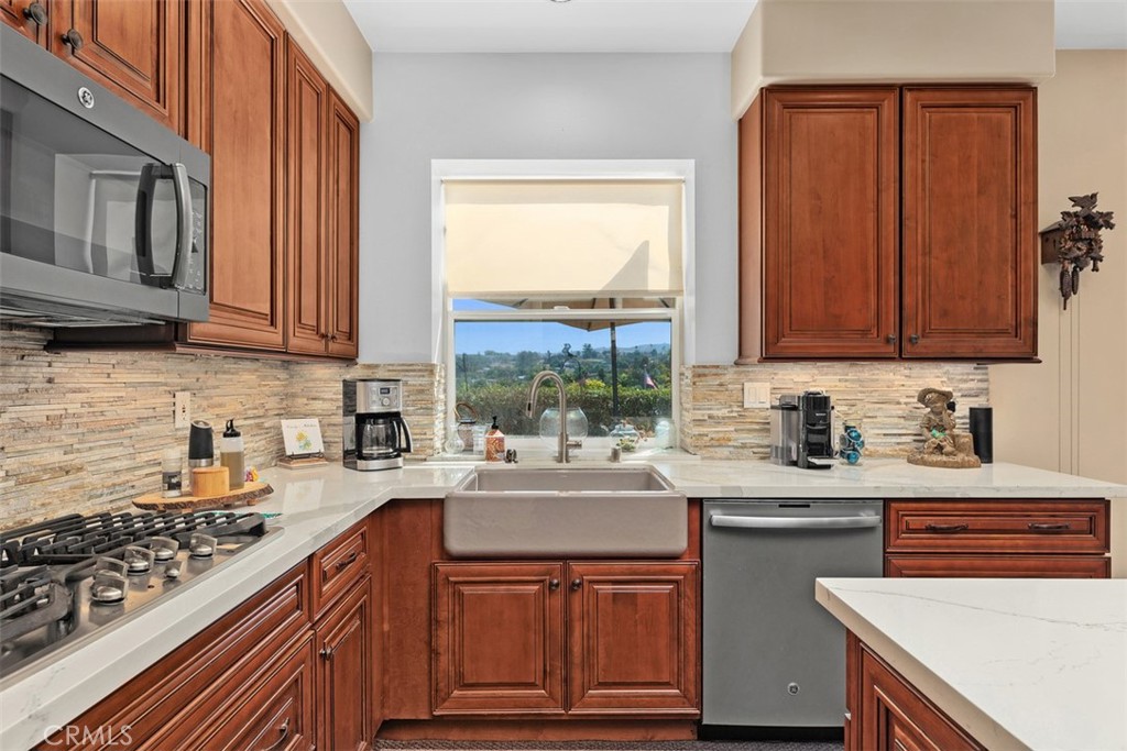 1957 Cresthaven Drive Vista, CA 92084 - Photo 11 of 47 a kitchen with a sink stove top oven and cabinets