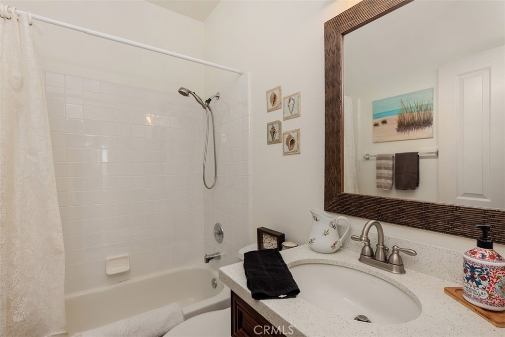 1957 Cresthaven Drive Vista, CA 92084 - Photo 15 of 47 a bathroom with a tub sink and mirror