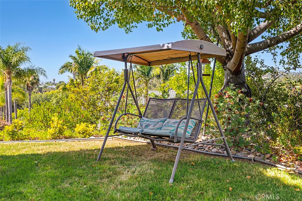 1957 Cresthaven Drive Vista, CA 92084 - Photo 46 of 47 a view of a backyard with a table and chairs under an umbrella