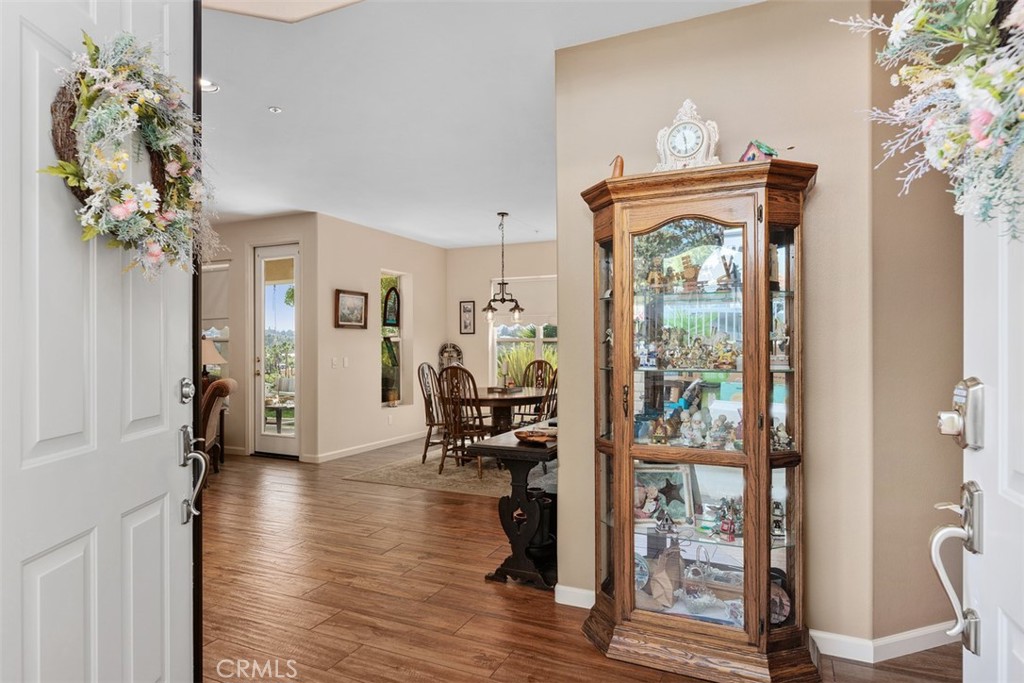 1957 Cresthaven Drive Vista, CA 92084 - Photo 5 of 47 a hallway with wooden floor and a chandelier