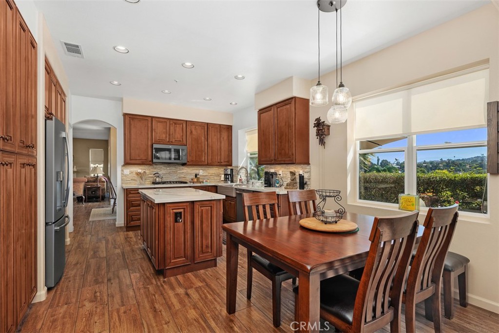 1957 Cresthaven Drive Vista, CA 92084 - Photo 9 of 47 a large kitchen with a table and chairs