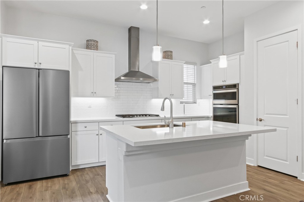 660 Daniel Freeman Circle Inglewood, CA 90301 - Photo 4 of 25 a kitchen with kitchen island a counter top space a stove and a refrigerator