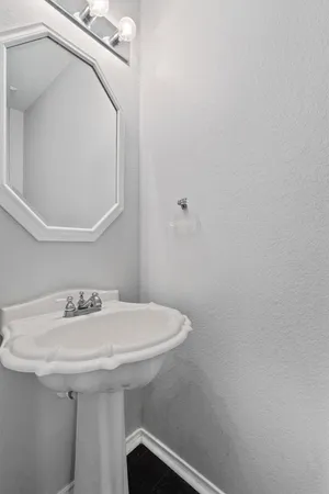 a bathroom with a sink and mirror