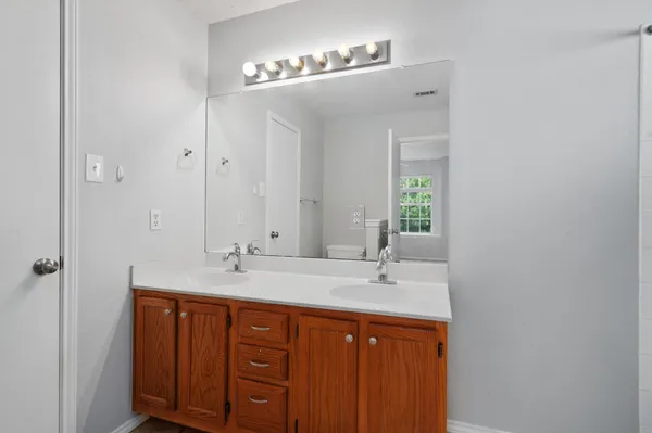 a bathroom with a double vanity sink and a mirror