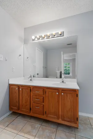 a bathroom with a double vanity sink and a mirror