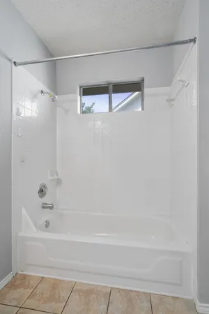 a bathroom with a shower and a bath tub
