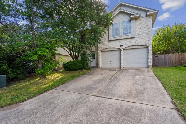a view of a house with a yard and garage