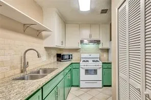 a kitchen with stainless steel appliances granite countertop a sink and a stove