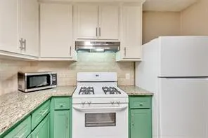 a kitchen with a stove and a microwave