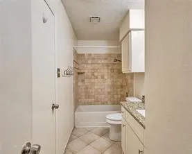 a bathroom with a toilet a sink and bathtub