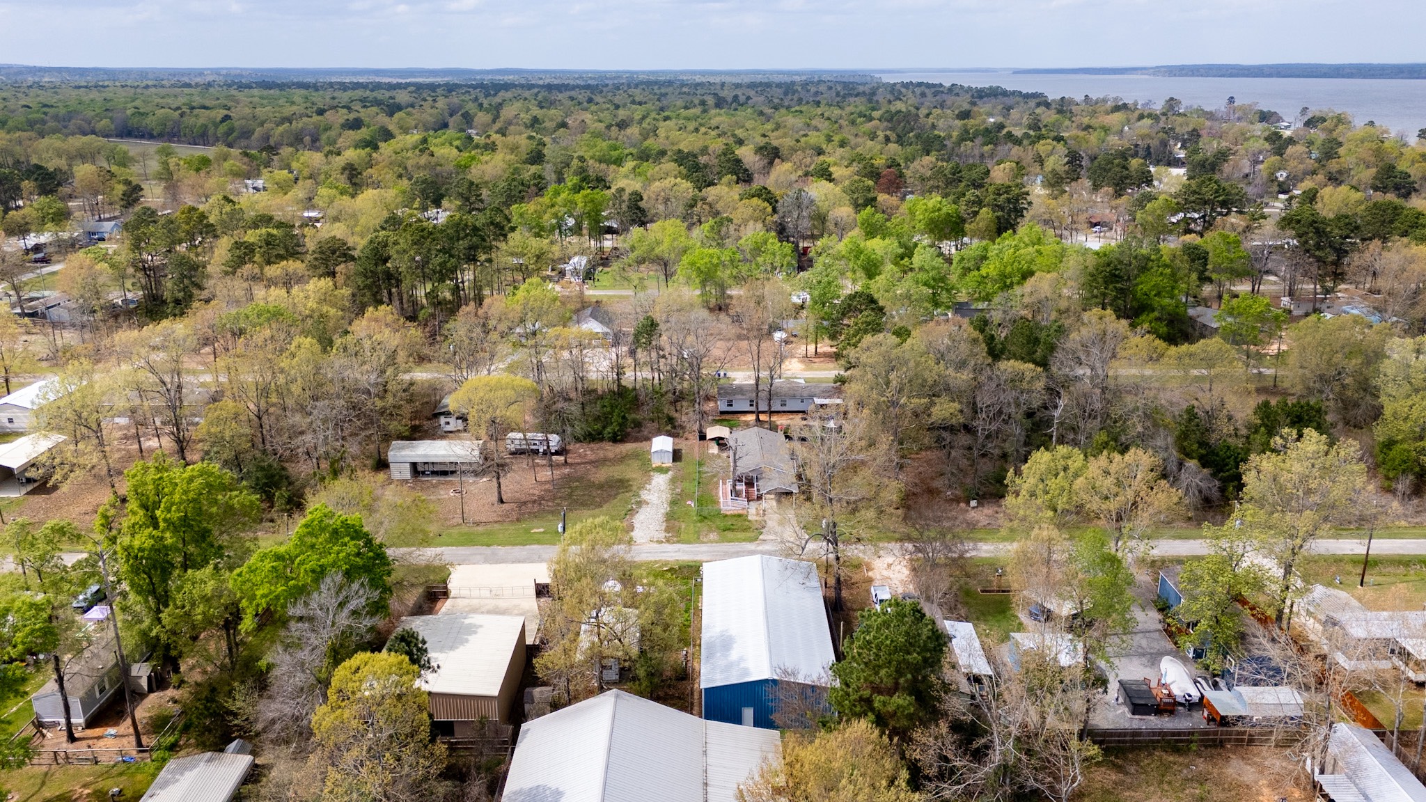 381 Antigua Drive Point Blank, TX 77364 - Photo 11 of 14 an aerial view of a city with lots of residential buildings and mountain view in back