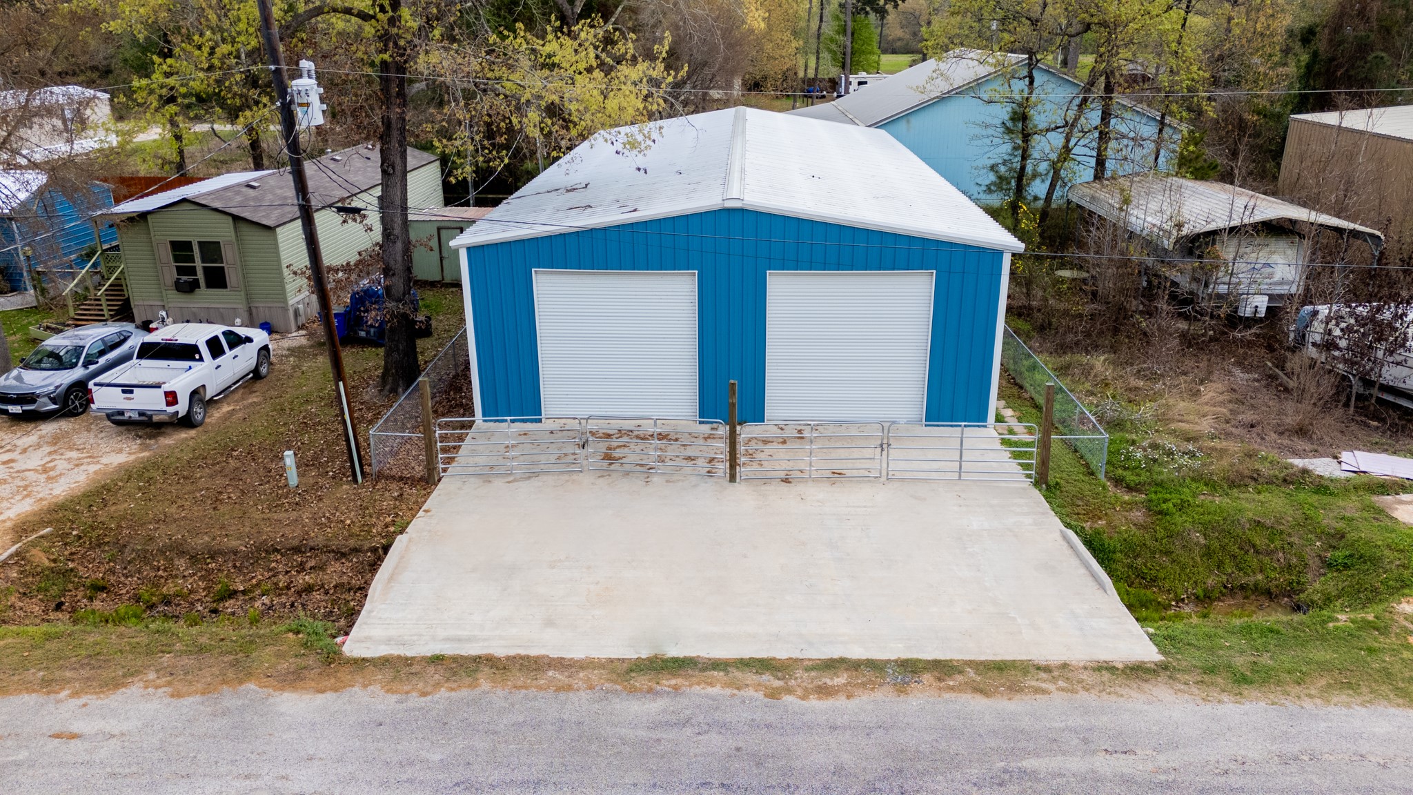 381 Antigua Drive Point Blank, TX 77364 - Photo 2 of 14 a view of a house with a yard and garage